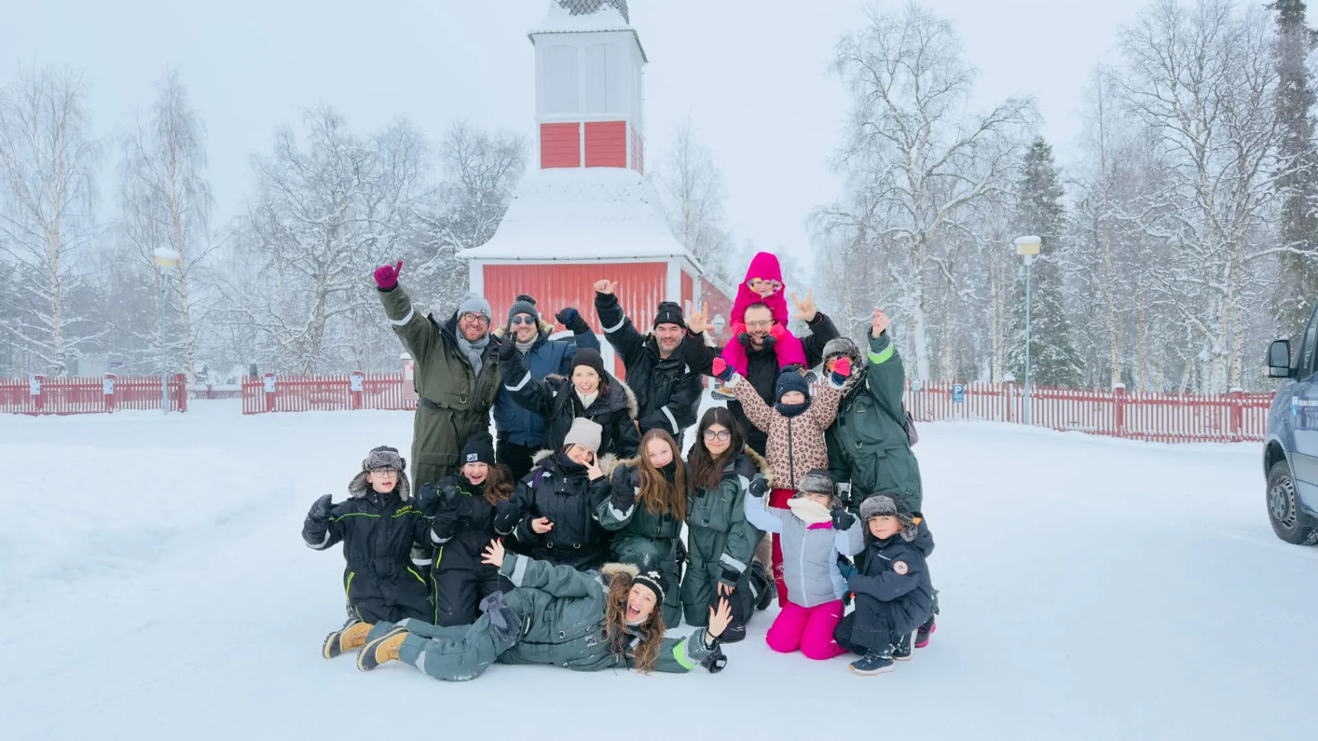 Smooth Aurora Travels guests with their local host in the snow outside Kiruna
